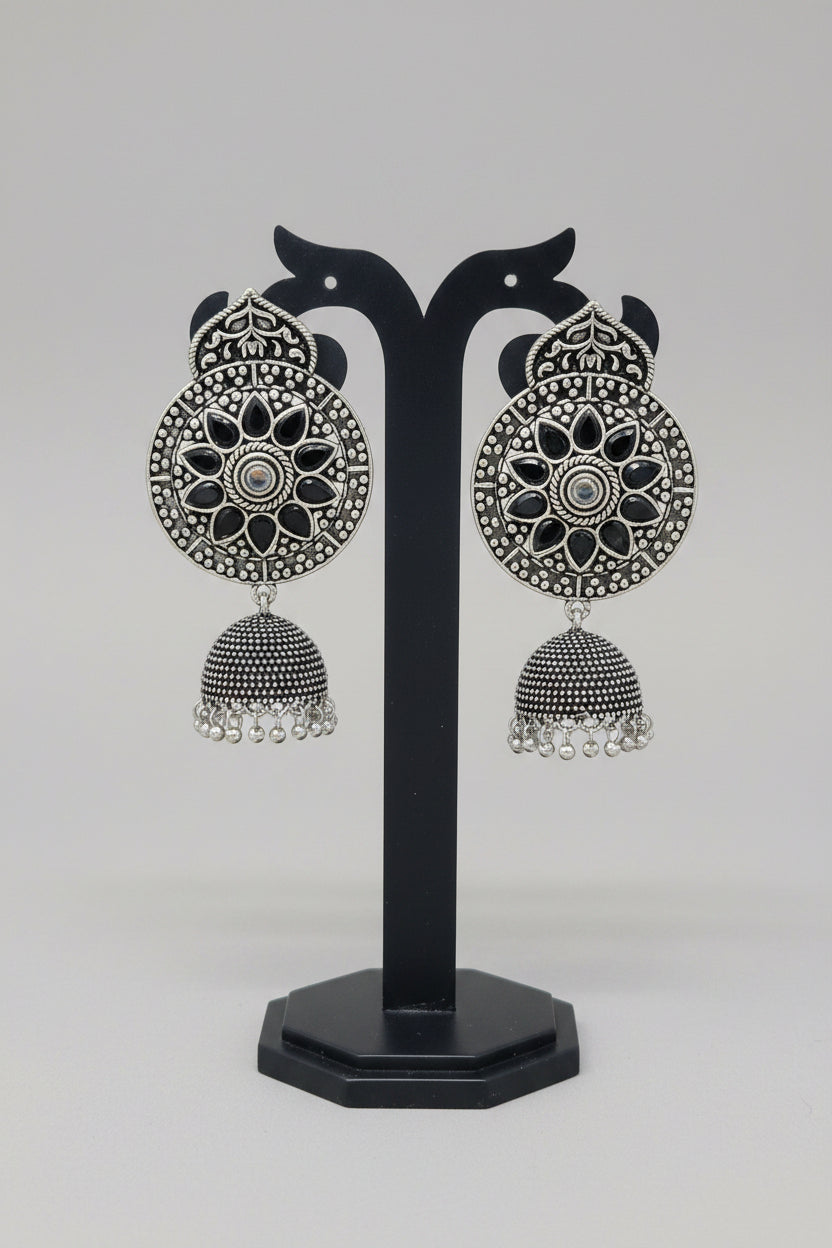 Premium oxidised handmade Ornate earrings with black stones and silver design.