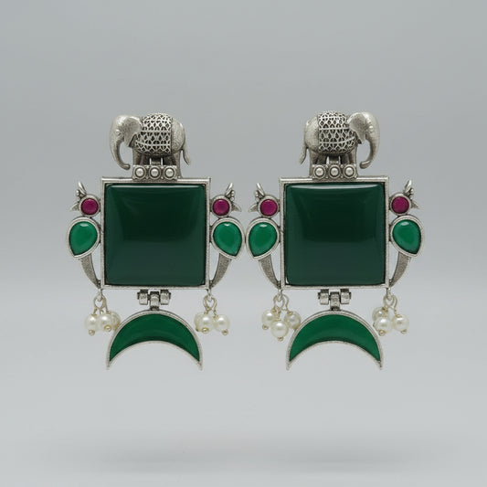 Pair of oxidised earrings with green square stones, green half moon stones, and silver elephant designs