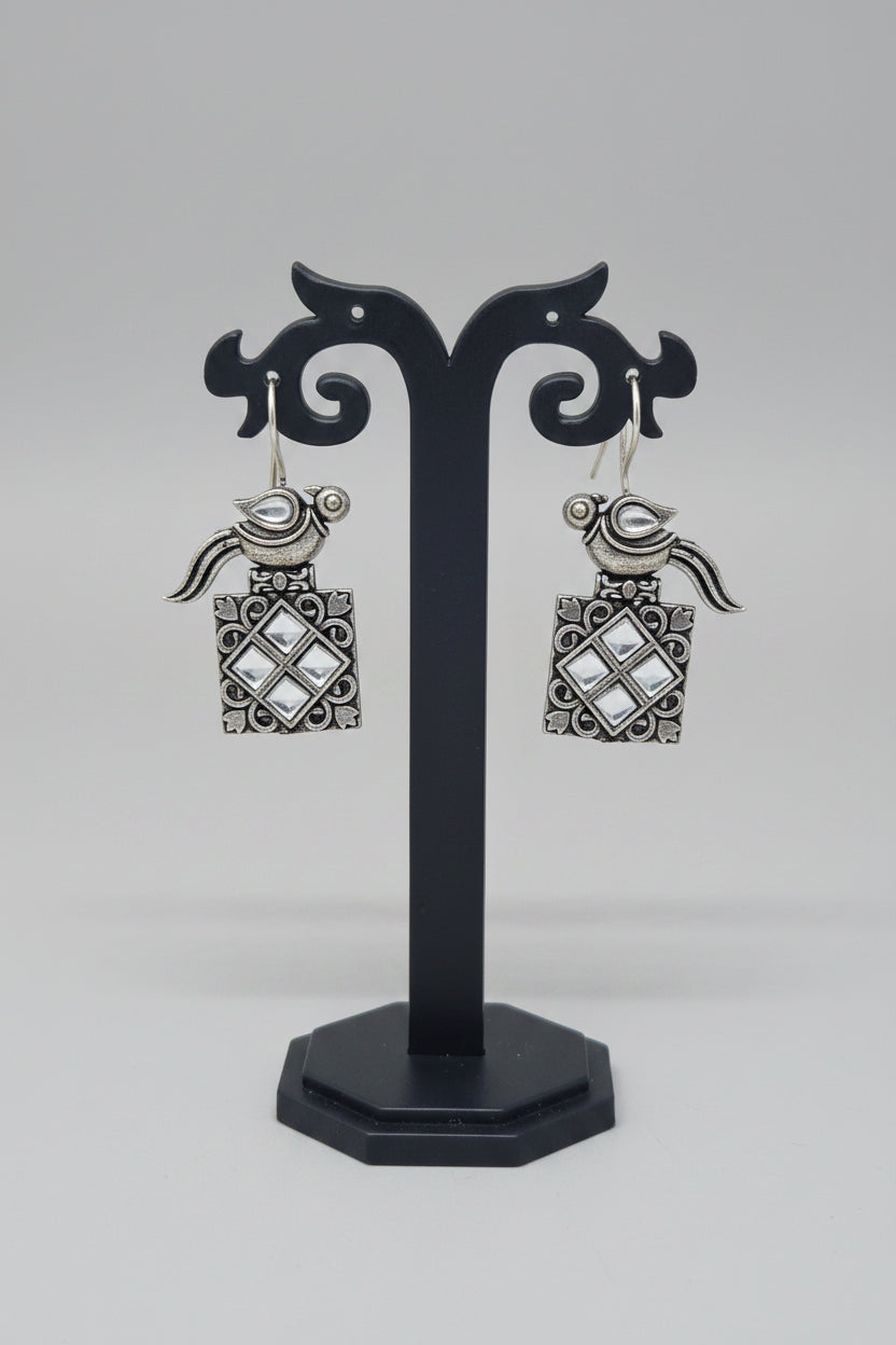 a pair of vintage oxidised bird motif drop earring with white gemstones