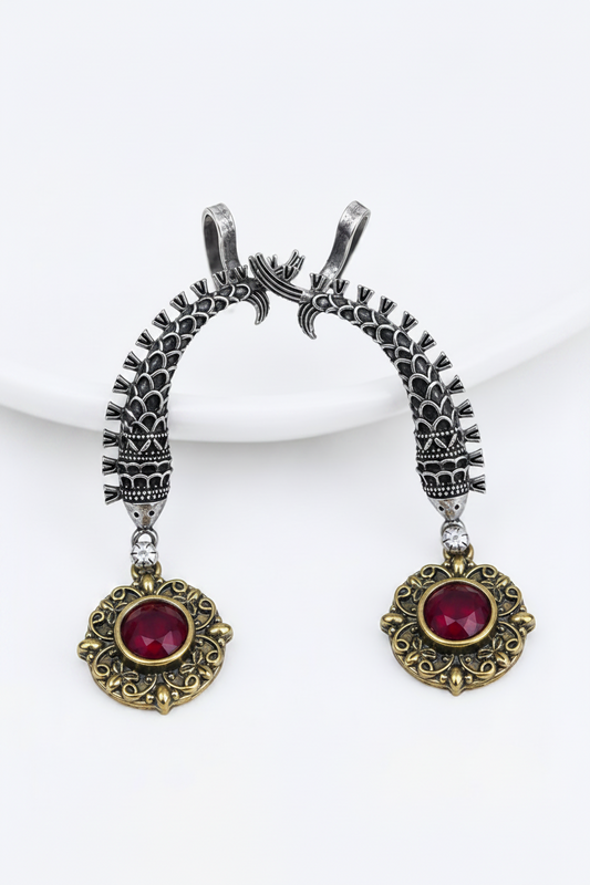 Antique oxidised silver ear cuffs with red semi-precious stone accents and intricate fish motif carvings.