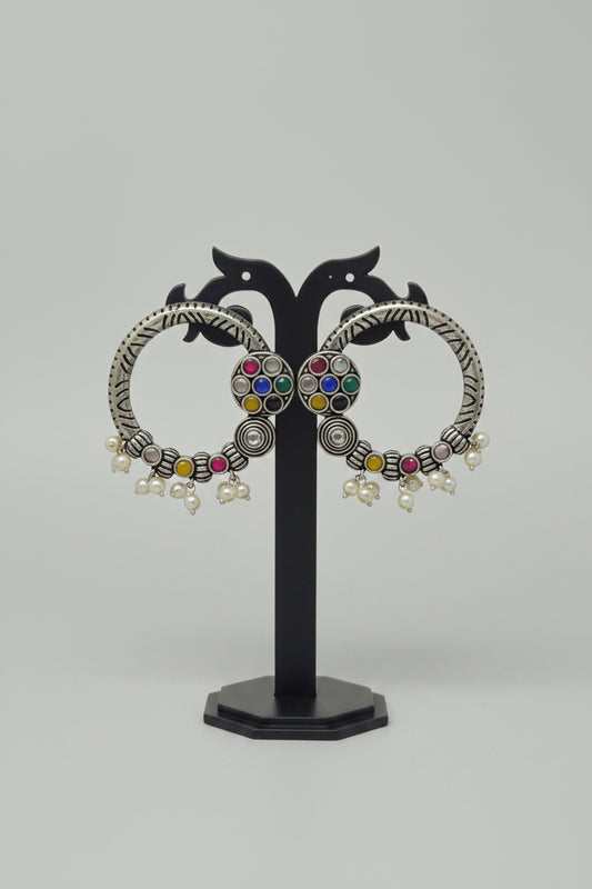 Pair of oxidised hoop earrings with navratna/multicolor gemstones.