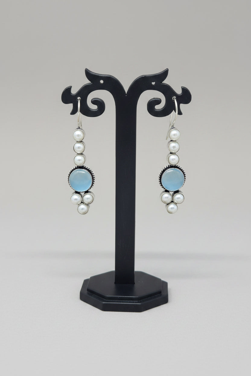 Pair of drop earrings with blue stones and pearls.