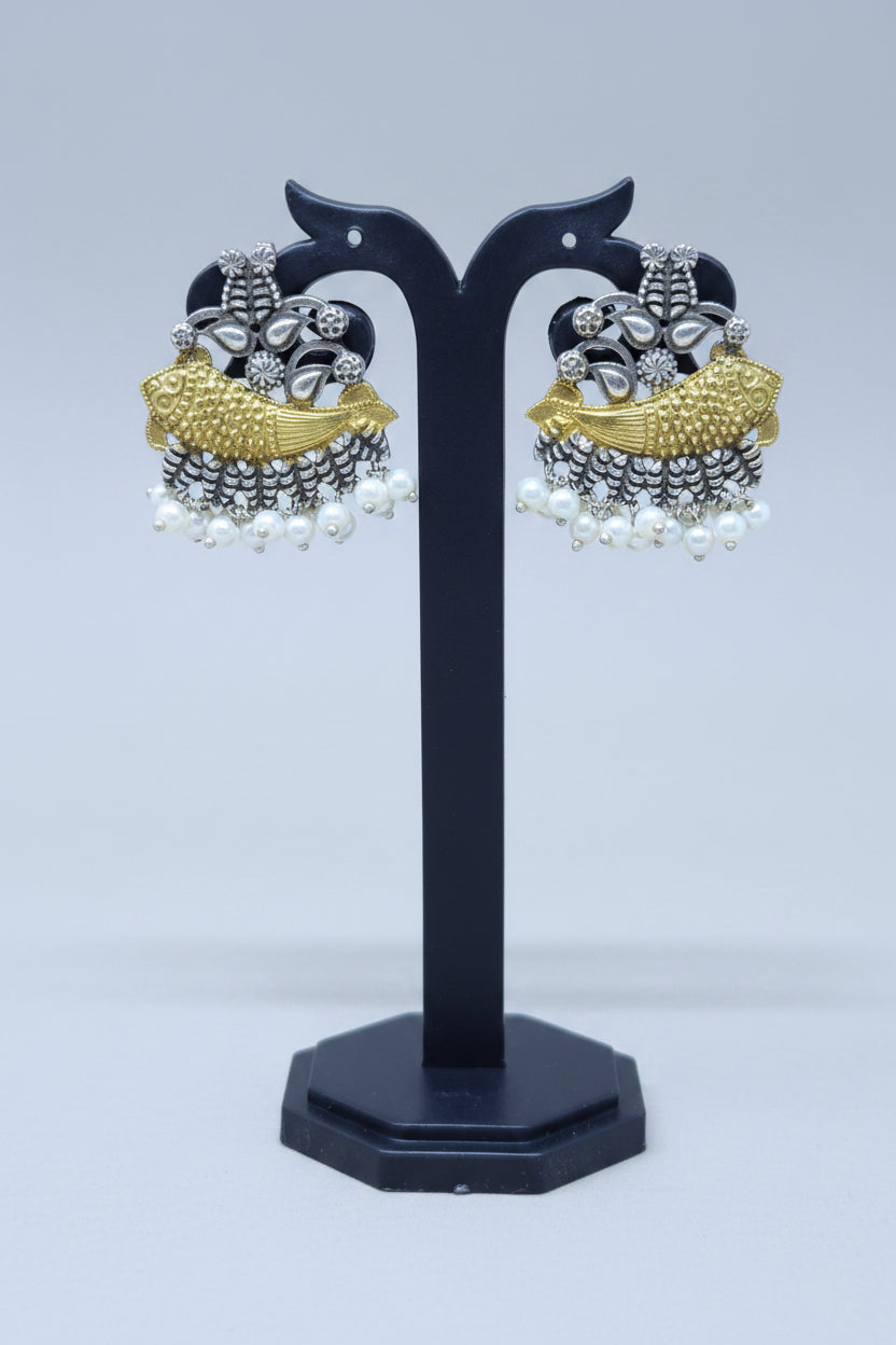 A pair of dual-toned fish motif earrings with gold-plated alloy and oxidized silver detailing, featuring a row of white pearls.