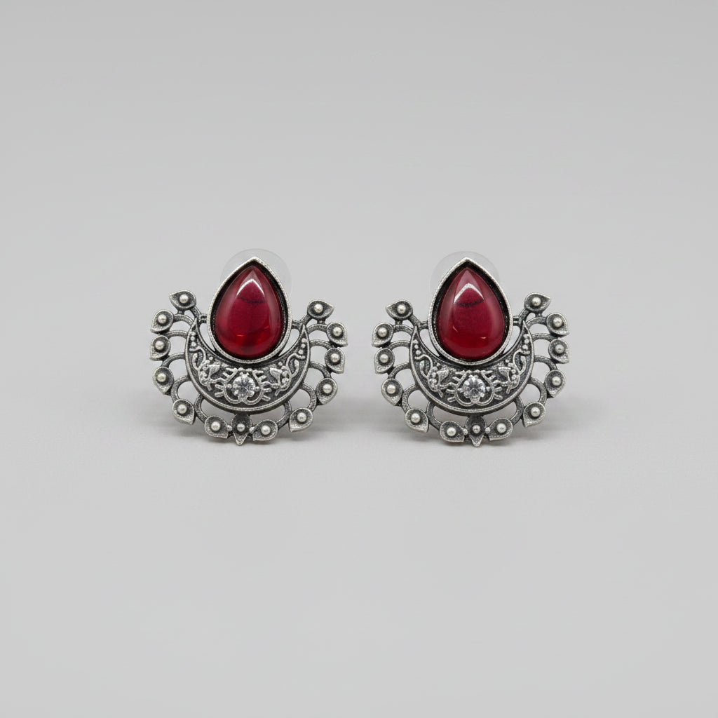 Oxidised silver stud earrings with teardrop red gemstones.