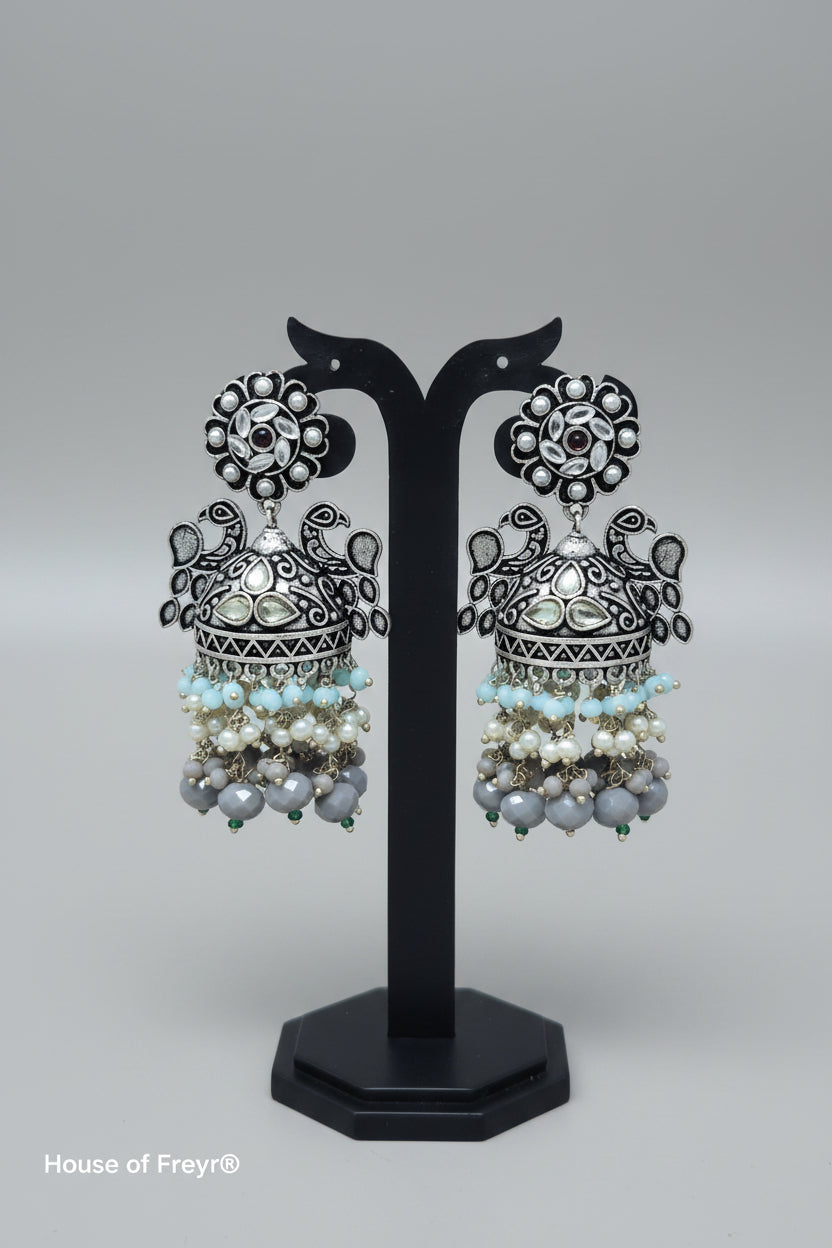 A pair of oxidized silver jhumka earrings with intricate Pachi Kundan work and grey color beaded 