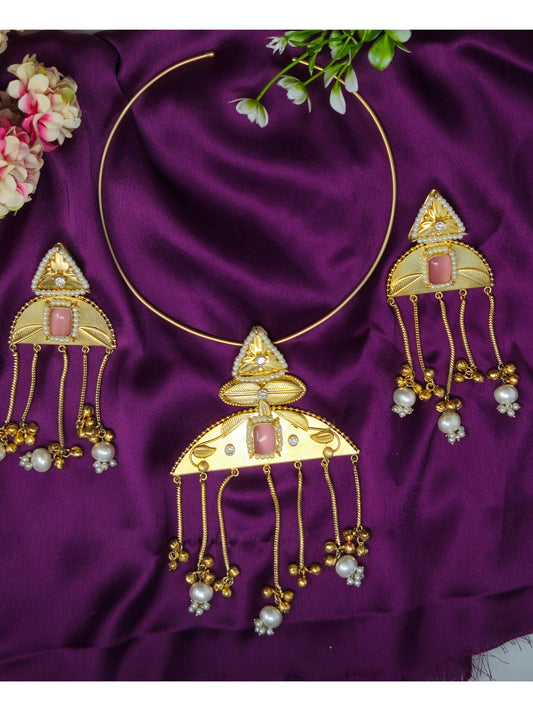 Gold jewelry set with pink stones and pearl beads