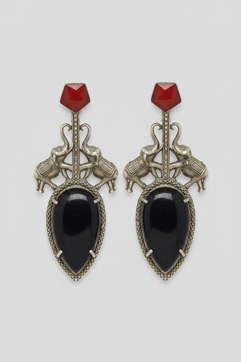 Pair of  stylish indo-western oxidised dangler earrings with big black stone, red tops, and elephant motif.