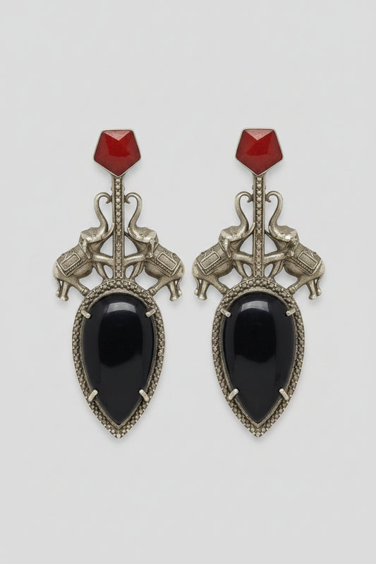 Pair of  stylish indo-western oxidised dangler earrings with big black stone, red tops, and elephant motif.