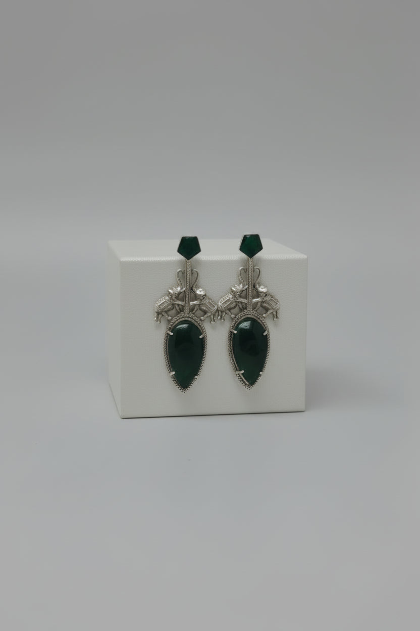 Pair of  stylish indo-western oxidised dangler earrings with bid green stone, green tops, and elephant motif.