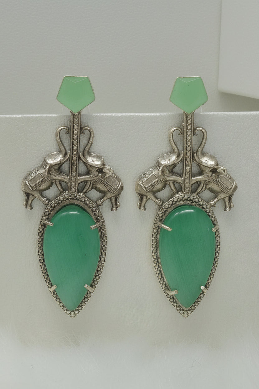 Pair of  stylish indo-western oxidised dangler earrings with bid cool mint stone, cool mint tops, and elephant motif.