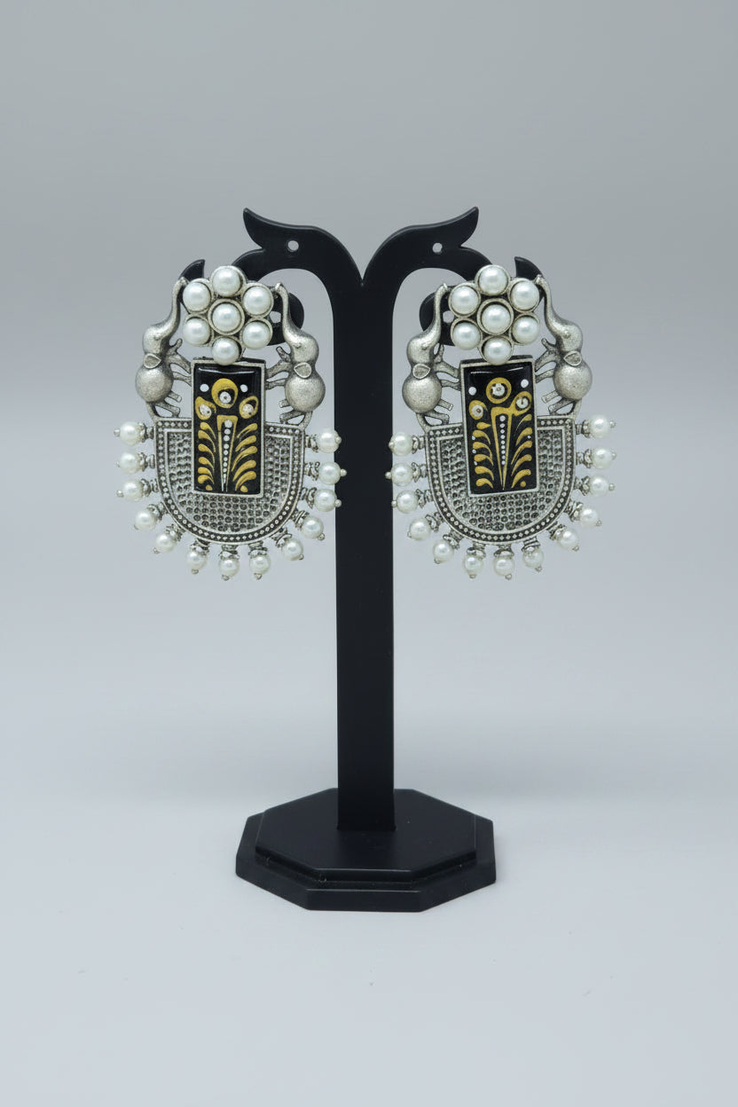 Pair of oxidised dangler with handmade Meenakari work on black moissanite stone, with pearls and elephant motif