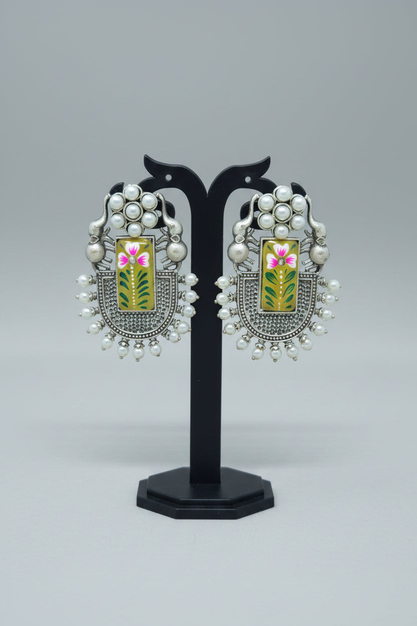 Pair of oxidised dangler with handmade floral Meenakari work on yellow moissanite stone, with pearls and elephant motif