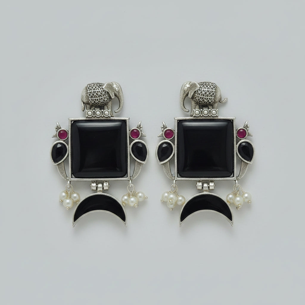 Pair of  oxidised earrings with black square stones,  black half moon stones, and silver elephant design.