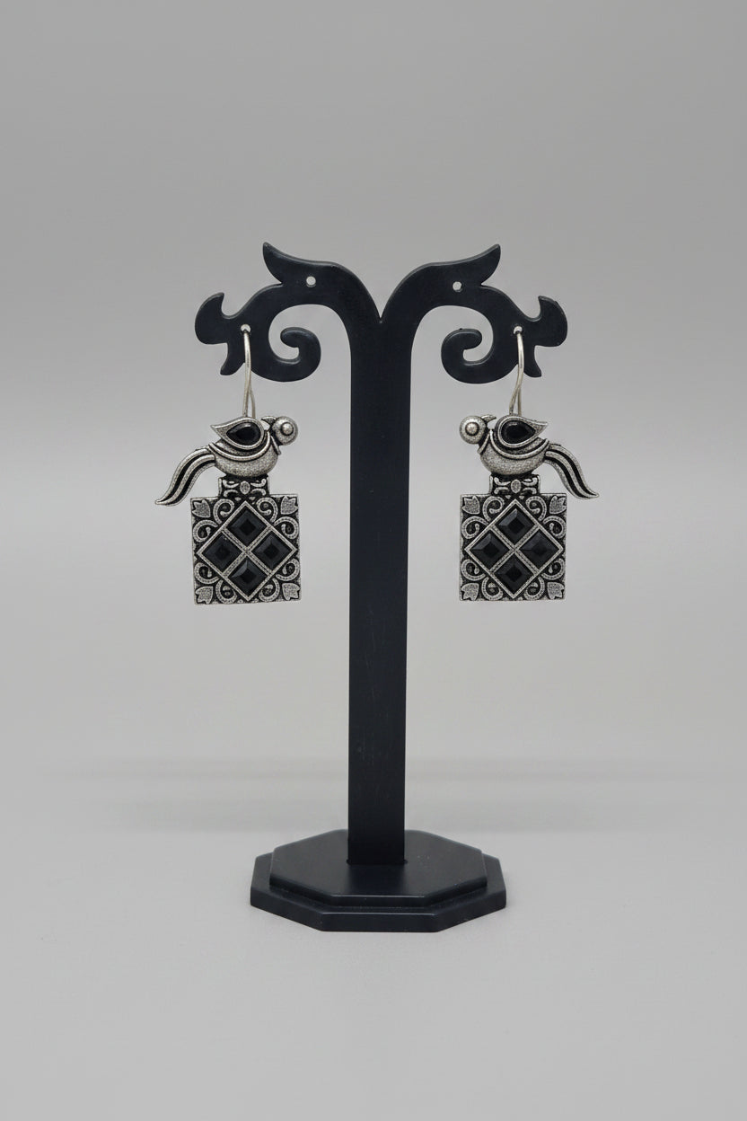 a pair of vintage oxidised bird motif drop earring with black gemstones