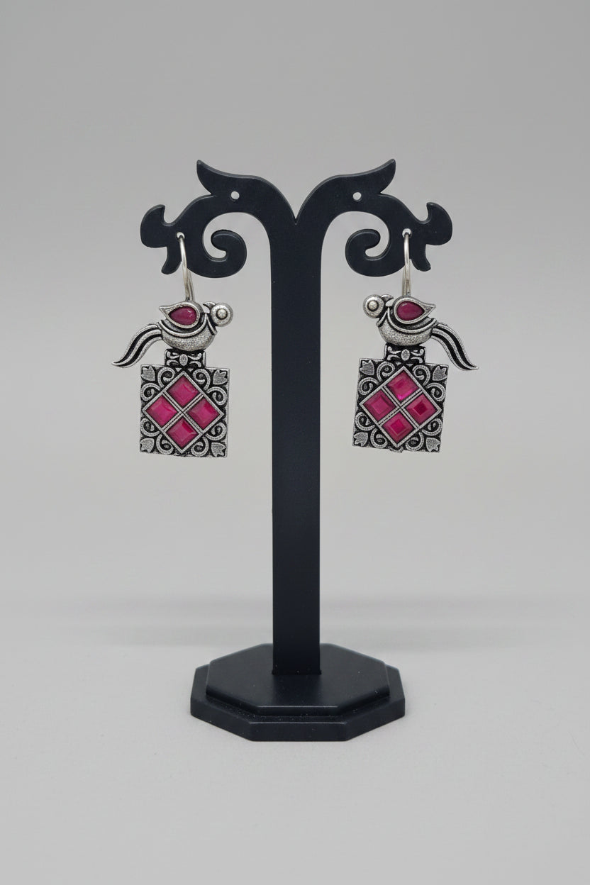a pair of vintage oxidised bird motif drop earring with red gemstones