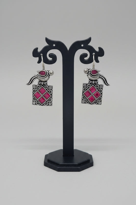a pair of vintage oxidised bird motif drop earring with red gemstones