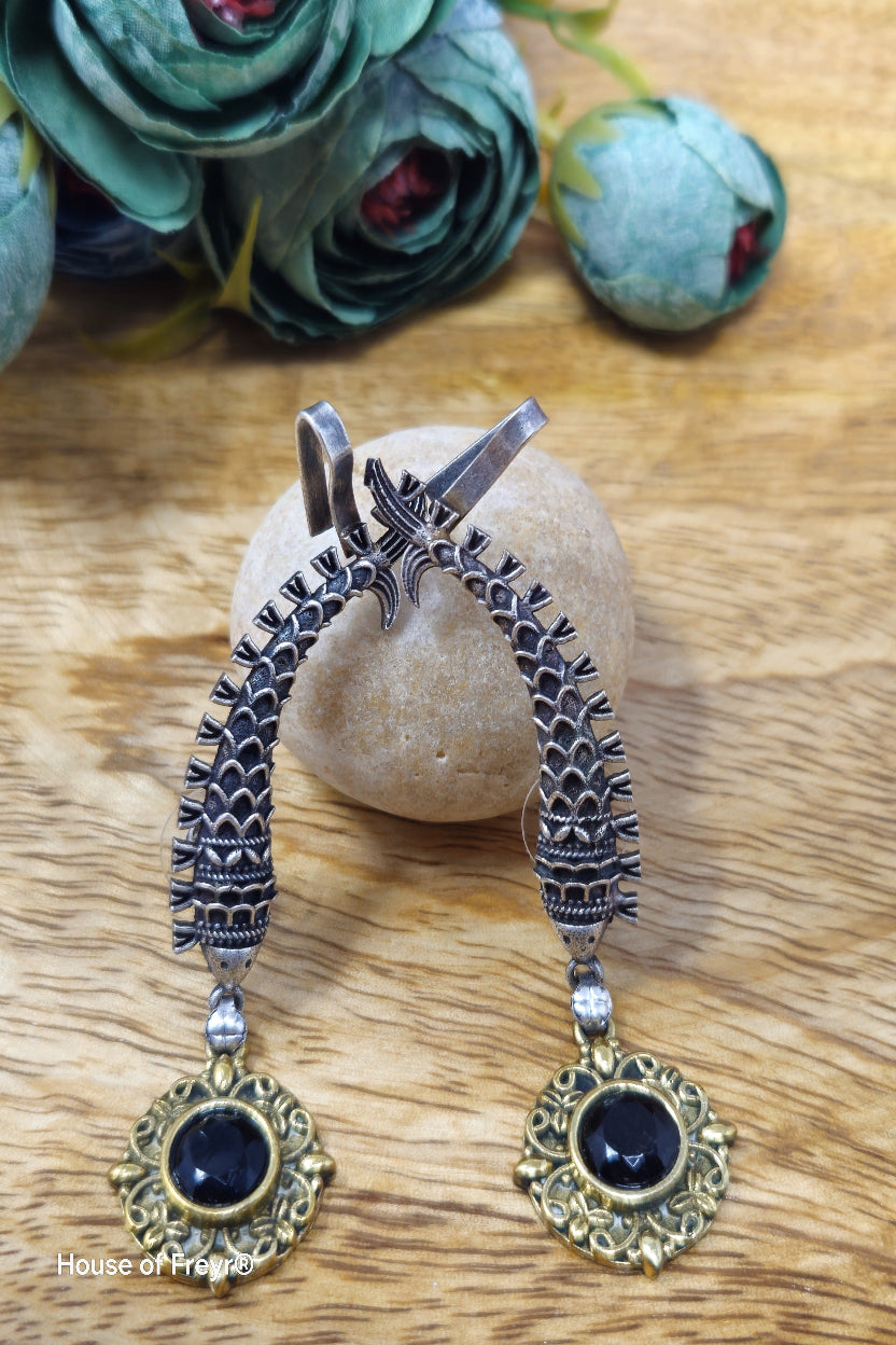 Antique oxidised silver ear cuffs with black semi-precious stone accents and intricate fish motif carvings.