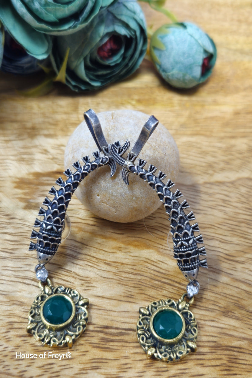 Antique oxidised silver ear cuffs with green semi-precious stone accents and intricate fish motif carvings.