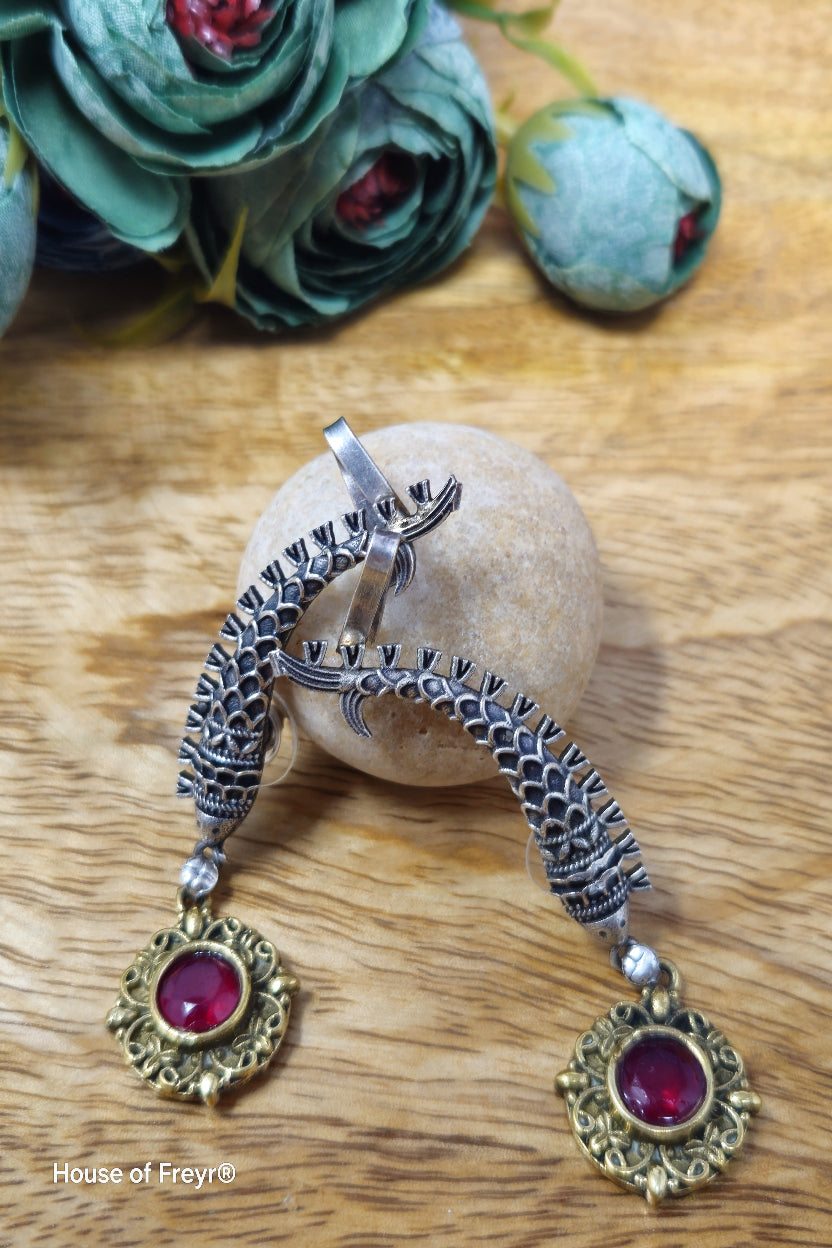 Antique oxidised silver ear cuffs with red semi-precious stone accents and intricate fish motif carvings.