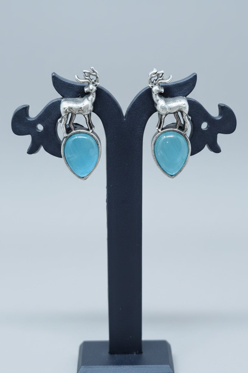 premium oxidised stud earrings featuring silver deer motifs on top of aqua teardrop-shaped semi-precious 