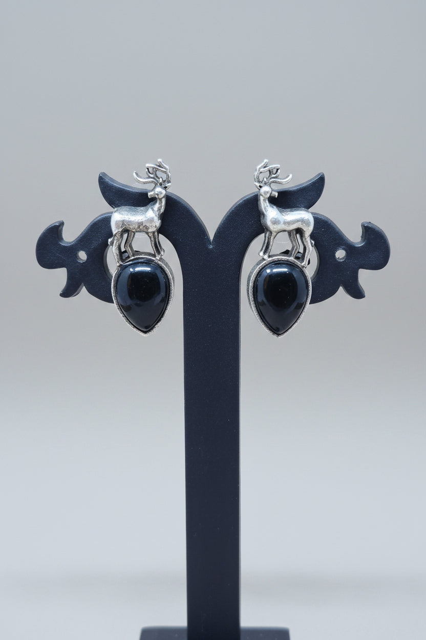 premium oxidised stud earrings featuring silver deer motifs on top of black teardrop-shaped semi-precious 