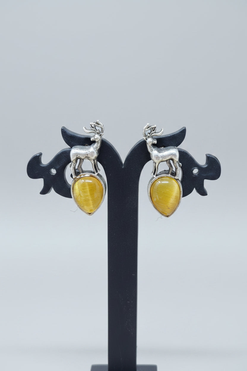 premium oxidised stud earrings featuring silver deer motifs on top of yellow teardrop-shaped semi-precious 