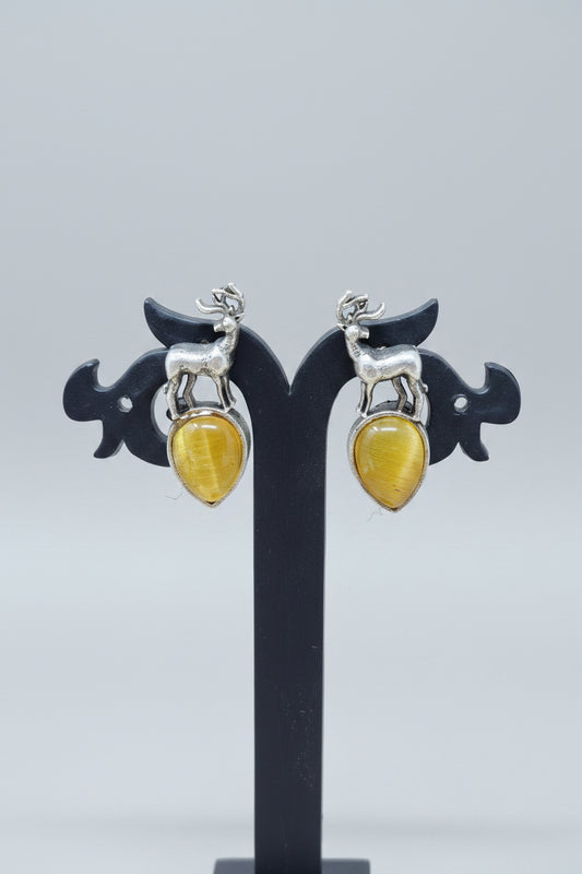 premium oxidised stud earrings featuring silver deer motifs on top of yellow teardrop-shaped semi-precious 