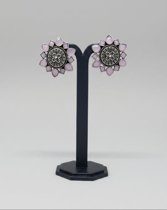 Pair of oxidised floral stud earrings with pink gemstone