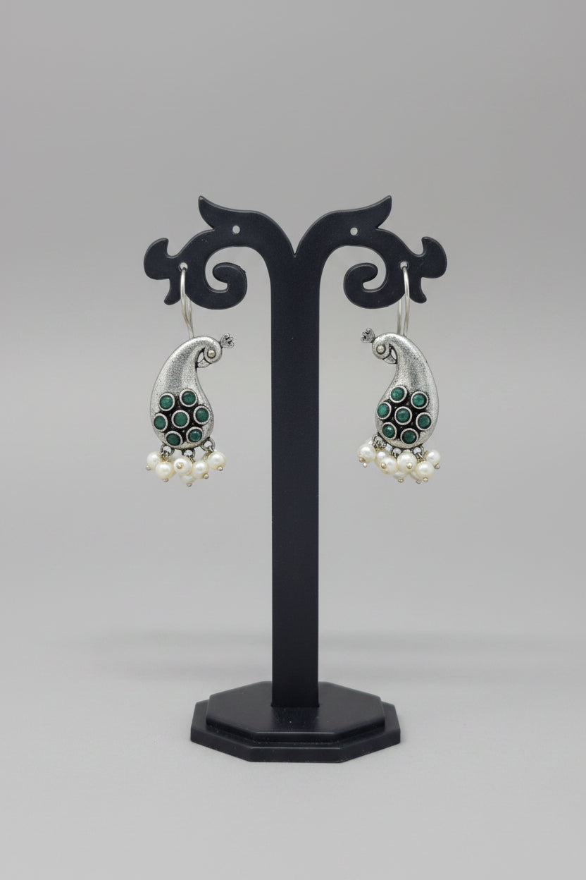 Premium oxidised antique silver peacock hook earrings with green colored stone accents and pearl drops.