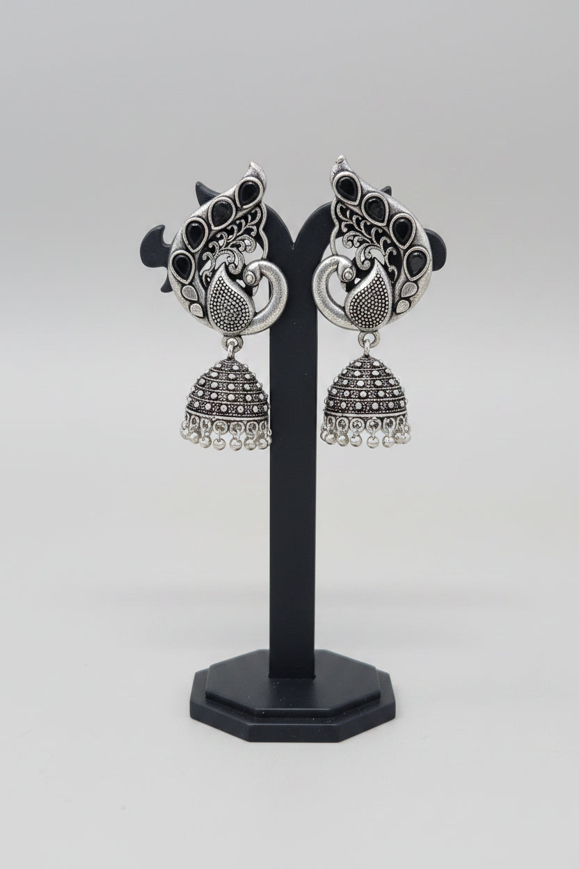 Pair of oxidised silver jhumka earrings, peacock motif with black gemstones.