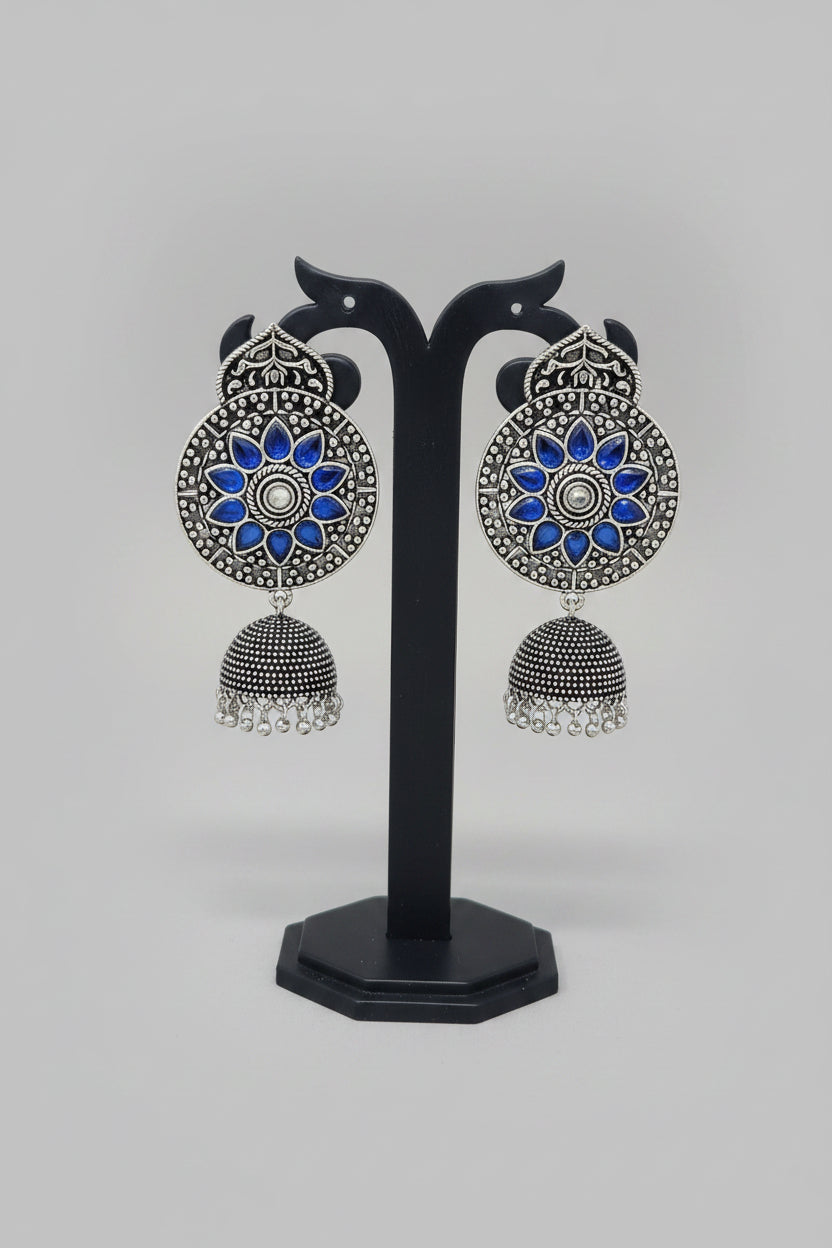 Premium oxidised handmade Ornate earrings with blue stones and silver design.