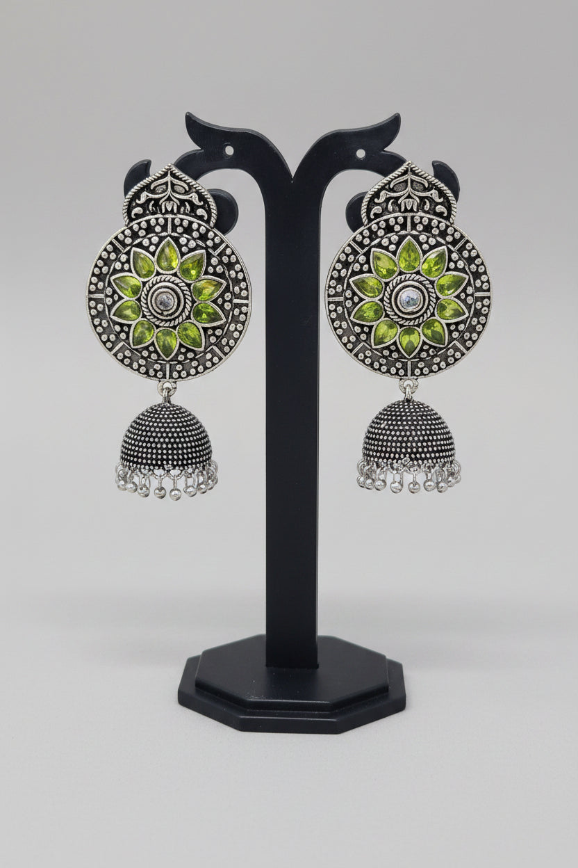 Premium oxidised handmade Ornate earrings with green stones and silver design.