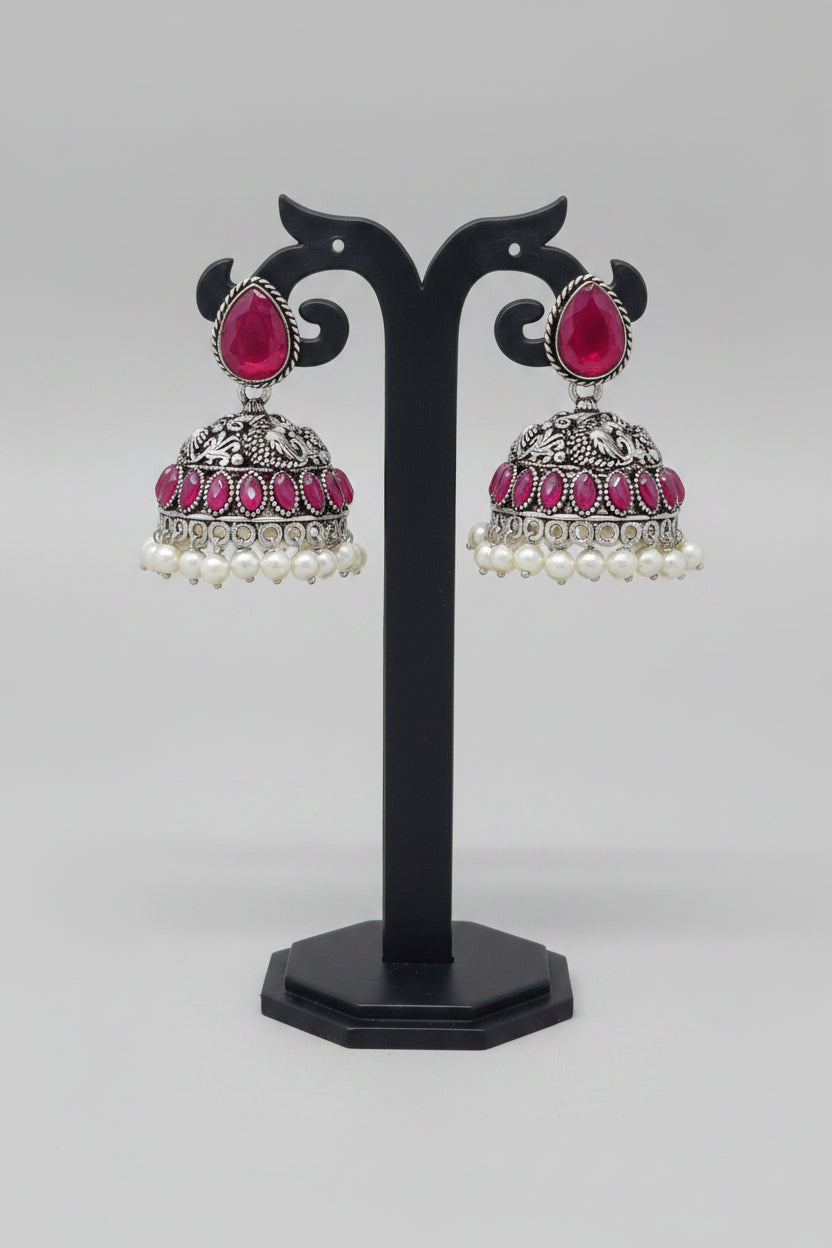 Pair of silver oxidised jhumki earrings with pearls and red moissanite stone