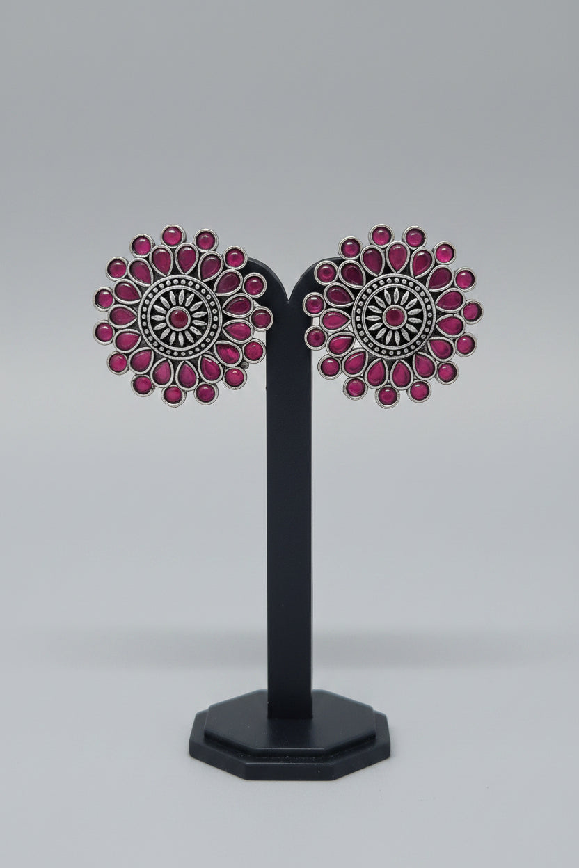 Antique oxidised Silver Sunburst Stud Earrings with intricate oxidized silver work, red semi-precious stones in a teardrop and circular setting.