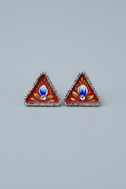 Handmade meenakari design, triangular stud earrings with red and yellow design on a gray background