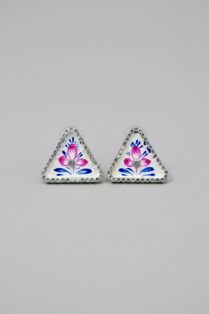 Handmade meenakari design, triangular stud earrings with floral design on a gray background